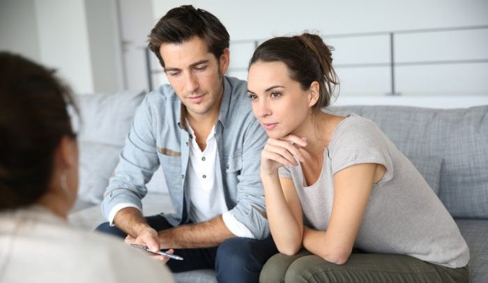 Couple meeting architect for house construction