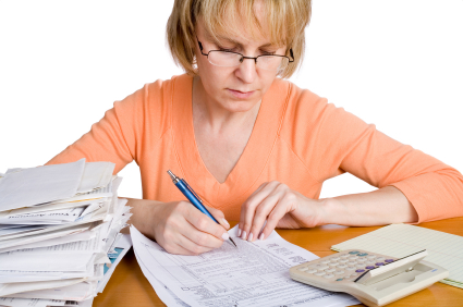 A woman filling out a income tax form